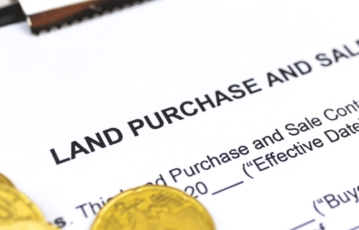 Close-up of a land purchase and sale contract titled "Land Purchase and Sale Contract"