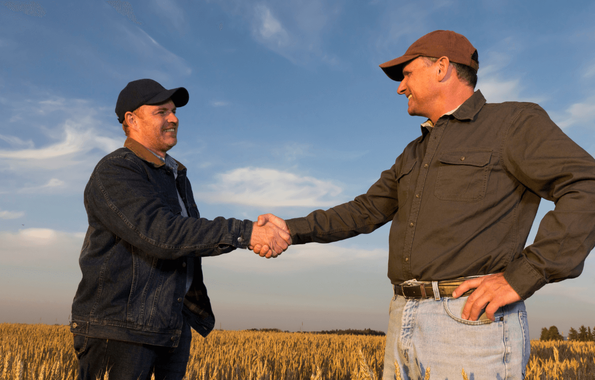 Two men shaking hands, agreeing to a deal.