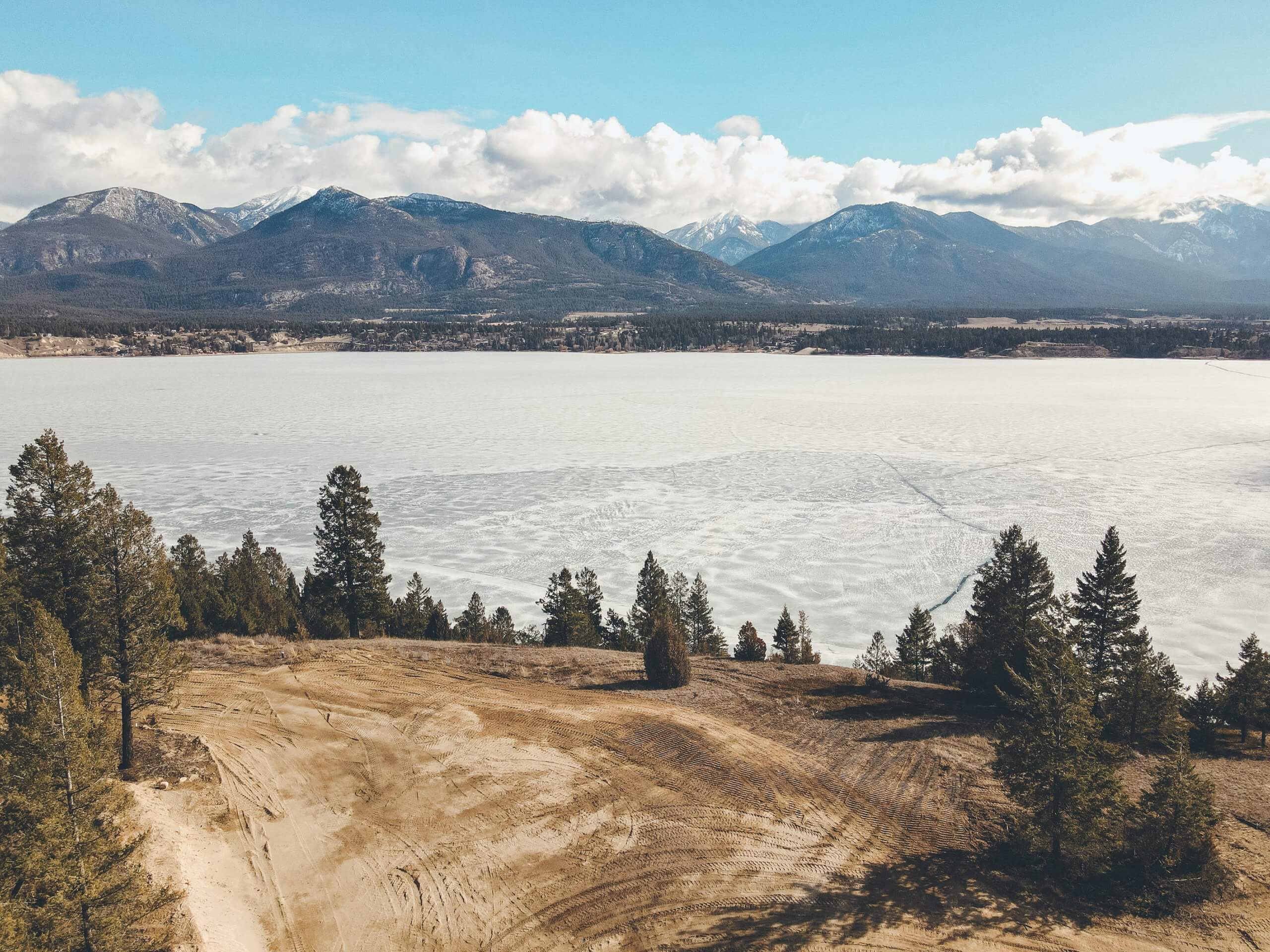 Frozen lake and forest near a mountain range